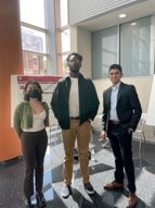 Three students standing in research panel